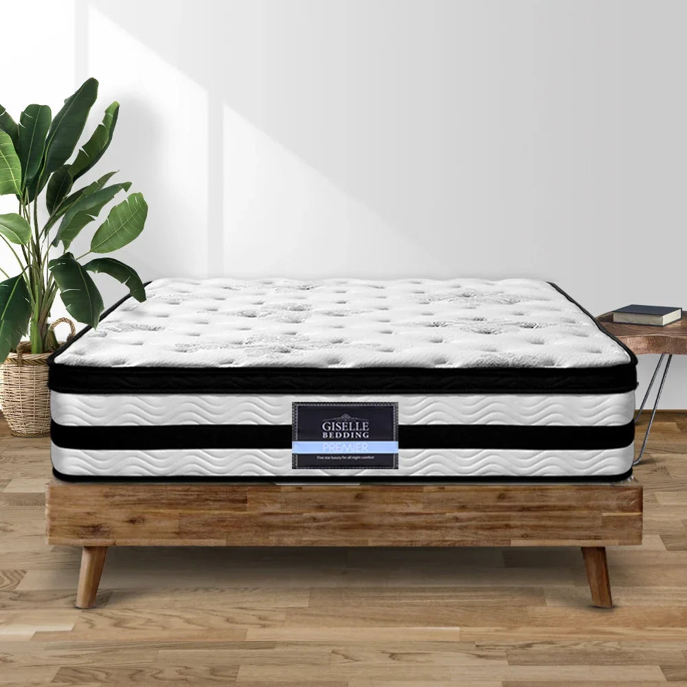 White mattress with black bands on a wooden bed frame, featuring the 'Giselle Bedding' brand.